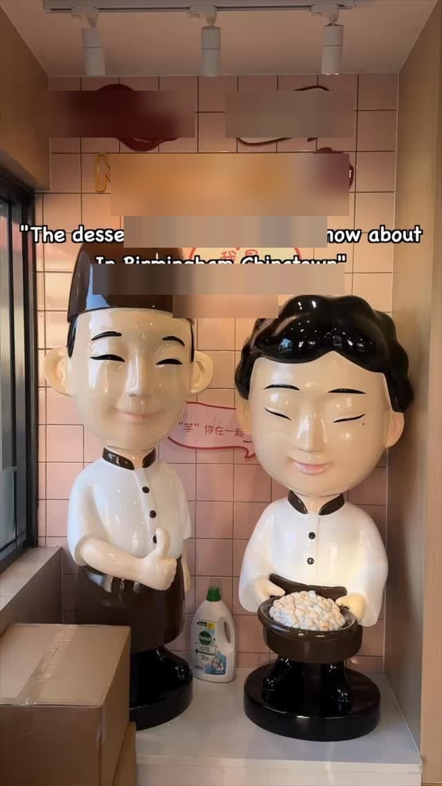 The two ceramic chef mascots on the pink Yuzu & Taro House brand wall — Birmingham, England.