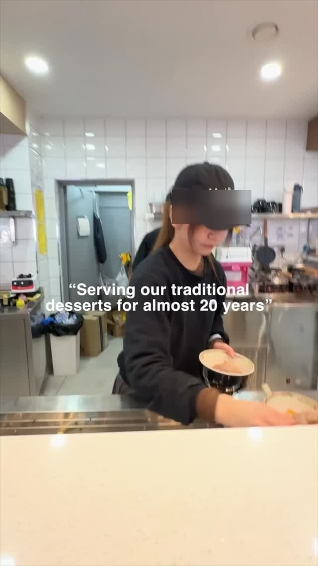 A team member behind the counter plating a fresh dessert — serving traditional desserts for almost 20 years.
